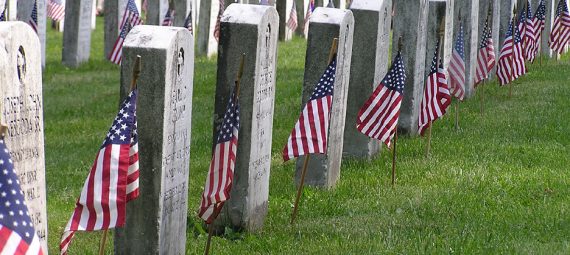 Memorial Day - Veteran's Cemetery with American Flags at each grave stone.