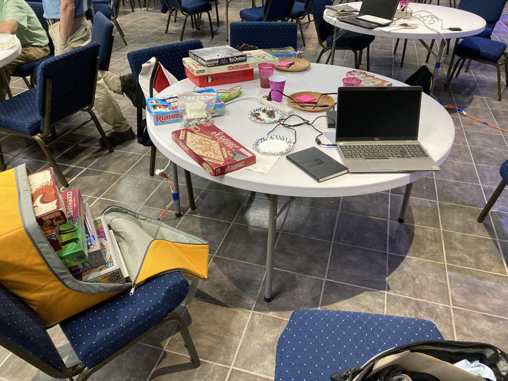 Table with games and a laptop. 