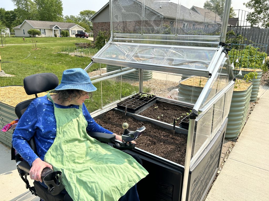 Angie Knight in front of our new accessible greenhouse.
