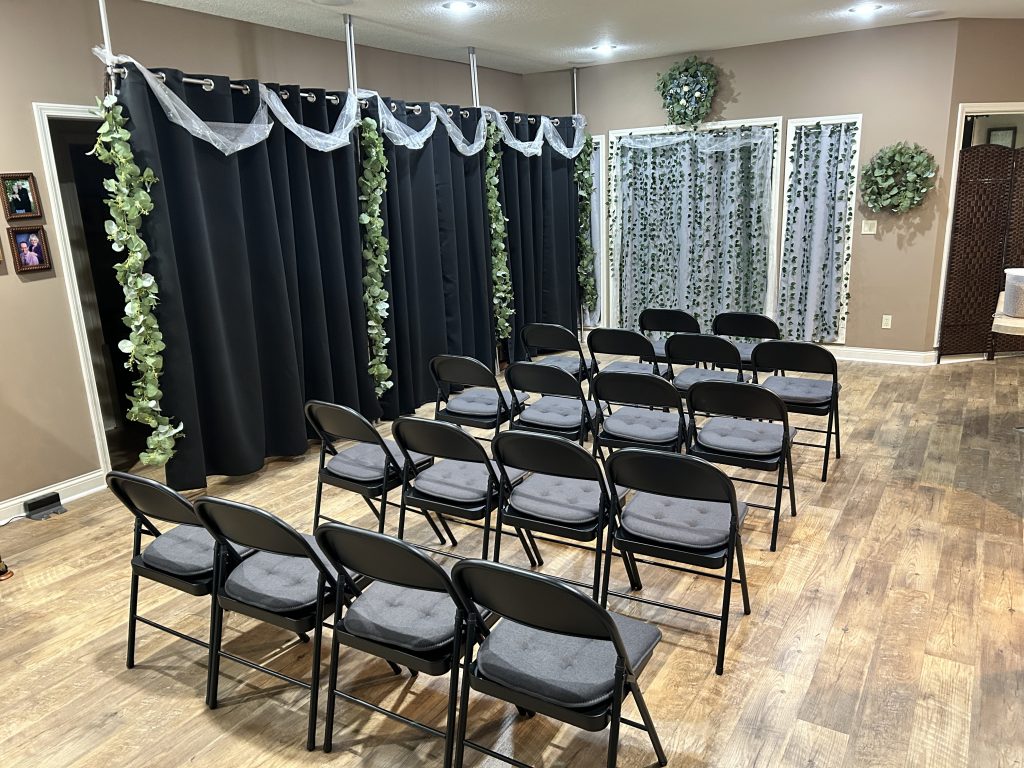 The miraculous conversion of the Knight house to a wedding chapel. T.R. came up with the curtain idea while Emily did the decorating. Chairs and decorated for wedding.